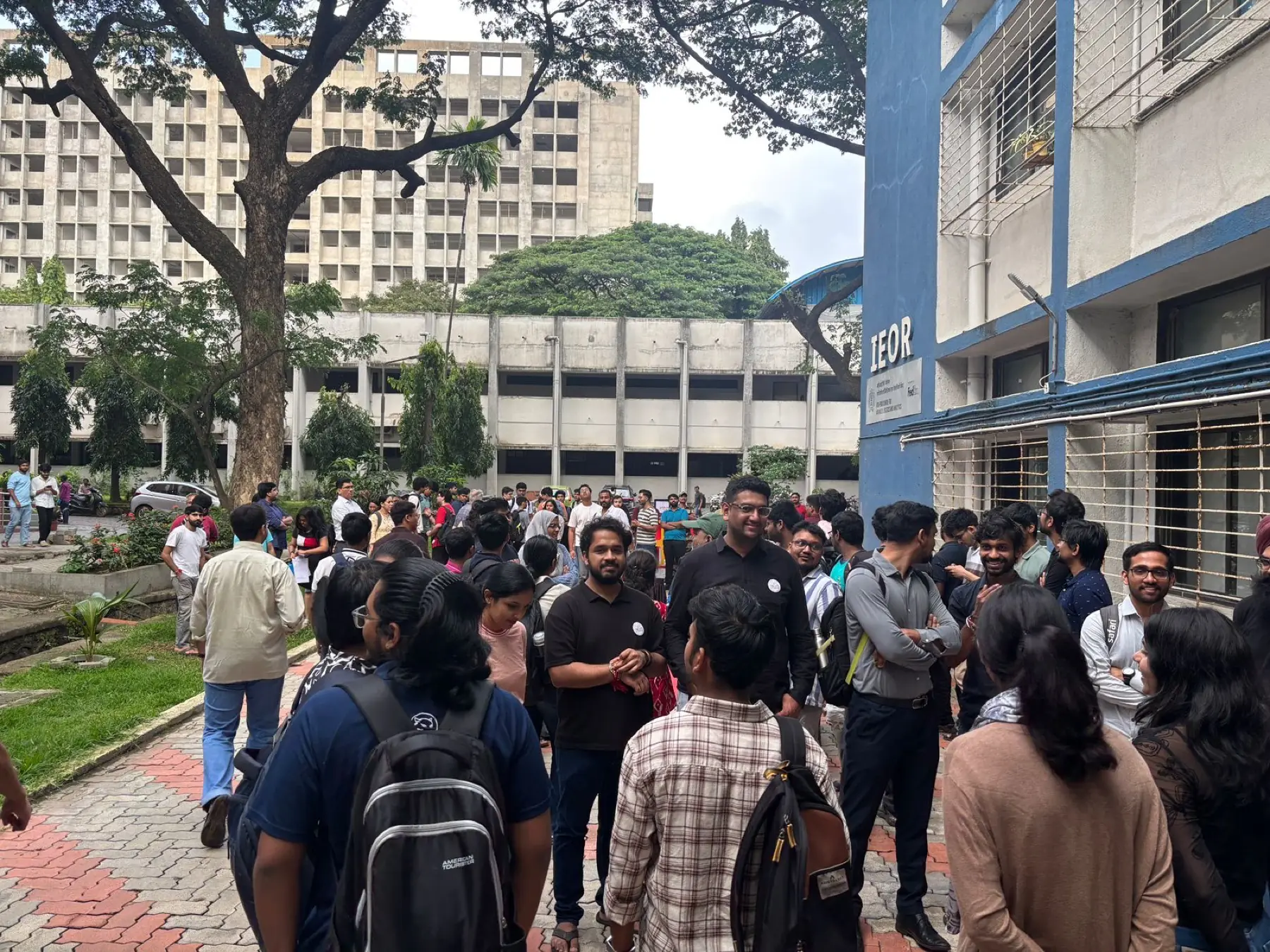 A crowd gathered along the path beside the IEOR building